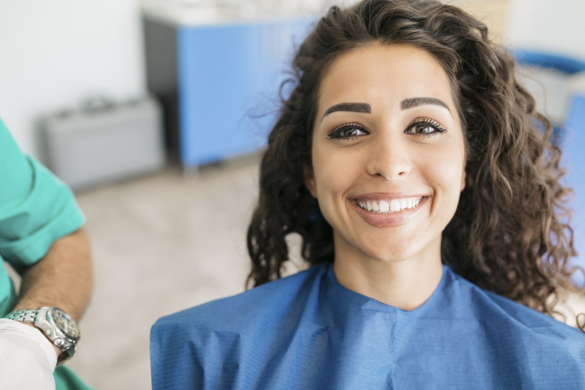 Portrait of a beautiful Caucasian woman sitting in a dentist's office